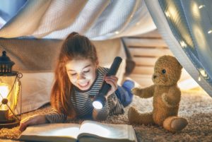 child is reading a book