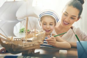 girl making model ship