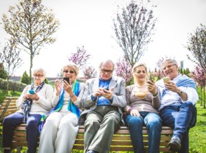 Senior people watching smartphones