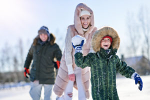 Nice happy family having fun on winter snow