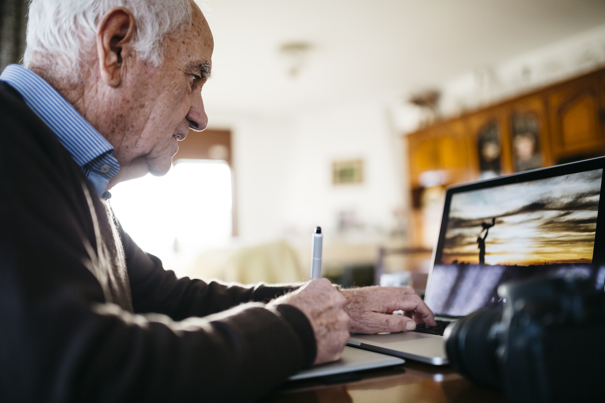 Senior photographer working with laptop