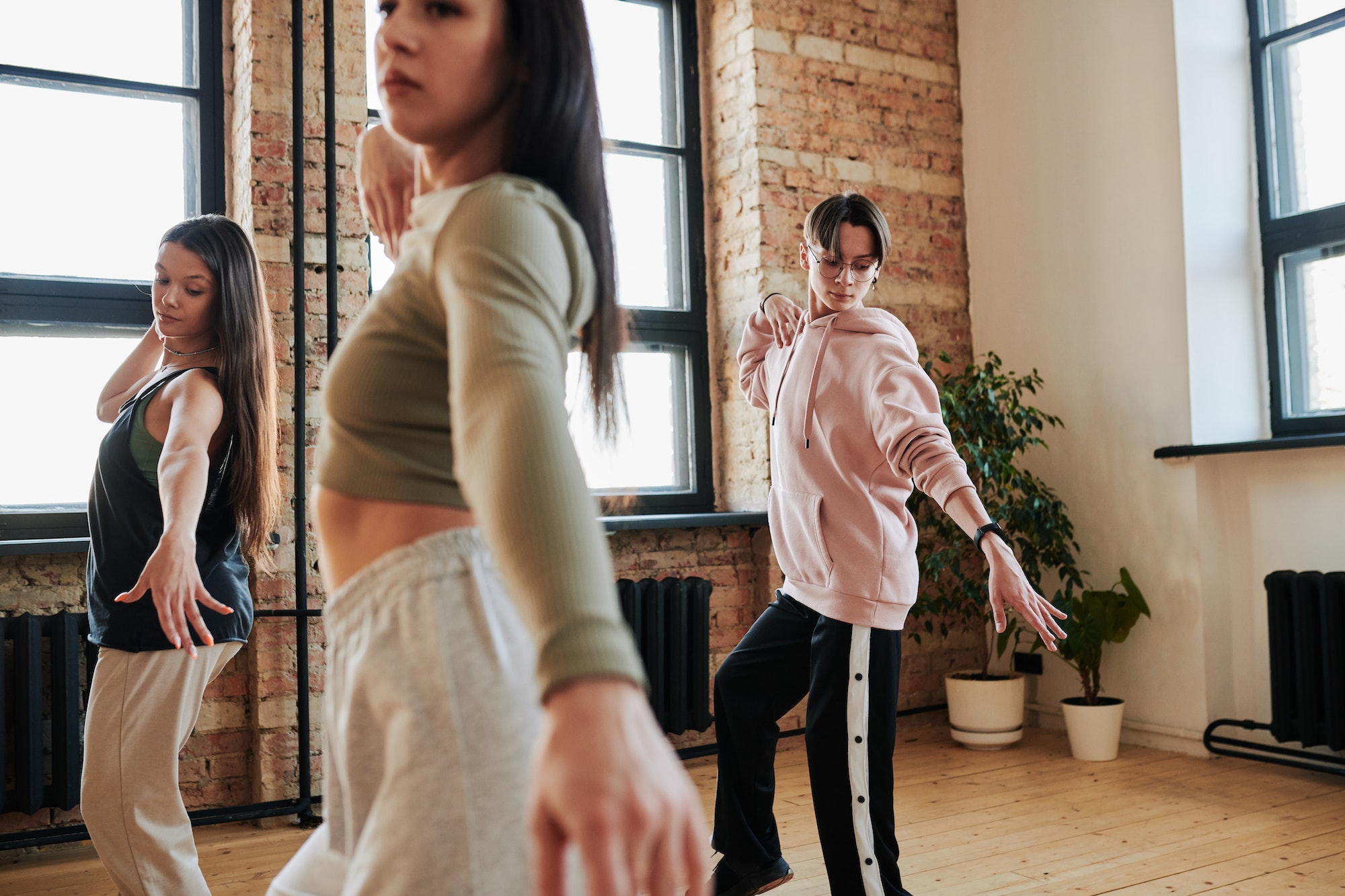 Group of contemporary teenagers in activewear practicing dance movements